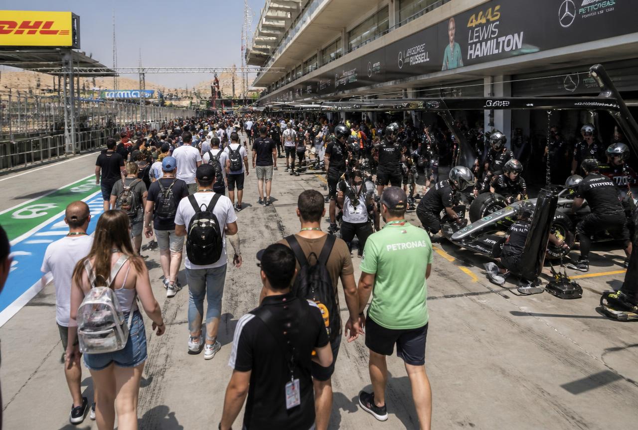 Guests on the Aramco F1 Pit Lane Walk in front of the team garages