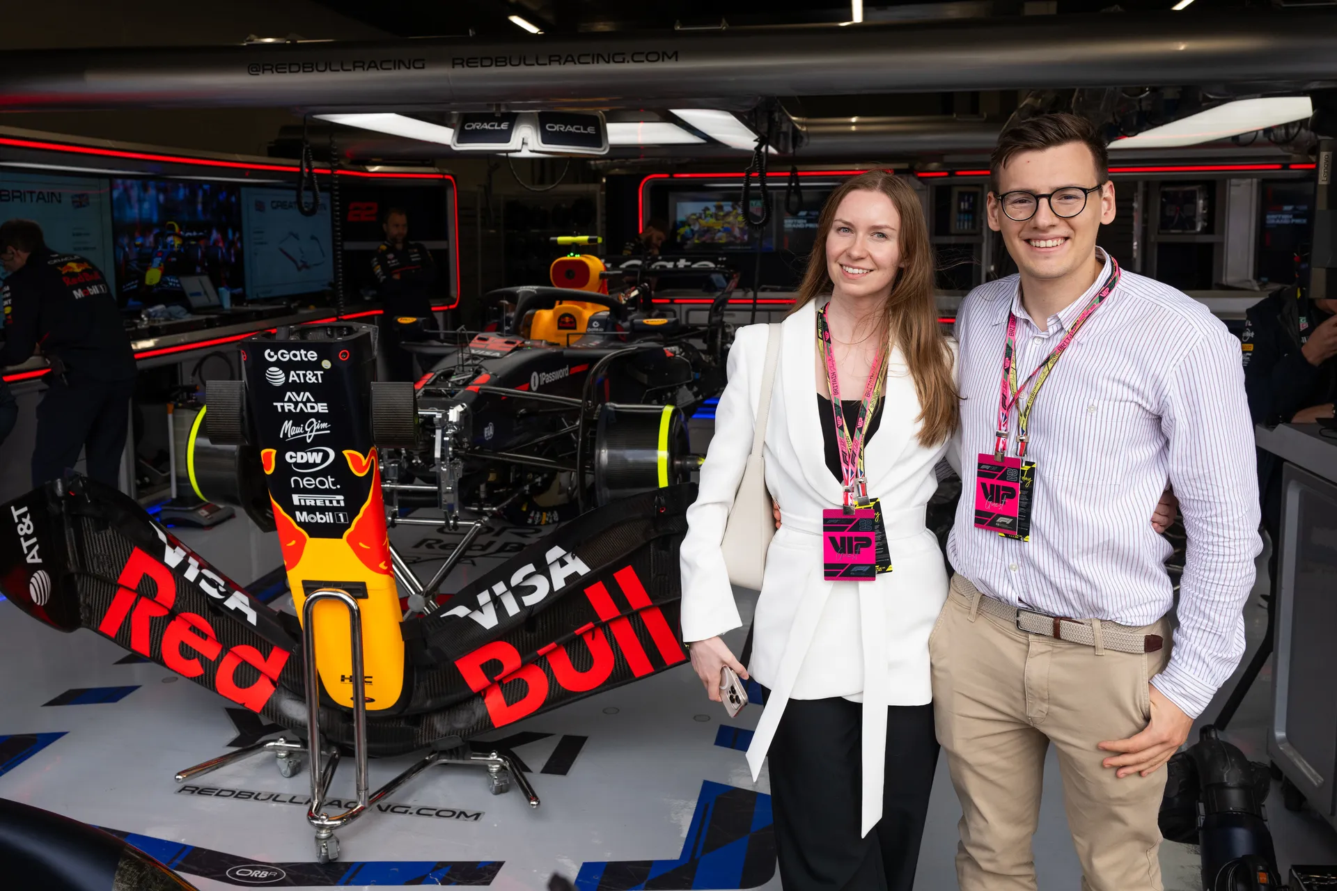 VIP guests inside the Oracle Red Bull Racing team garage with the F1 car
